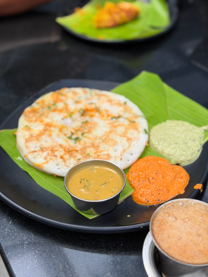 Crafting Captivating Headlines: Your awesome post title goes here Delicious South Indian Uttapam with coconut and tomato chutneys served on a banana leaf.